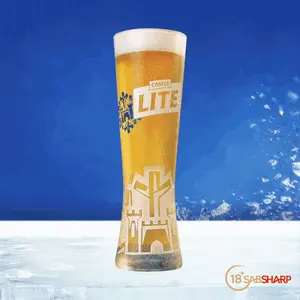 A Glass Of Castle Lite Beer With A Castle Design On It