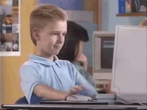 A Young Boy Sits At A Desk In Front Of A Computer Screen