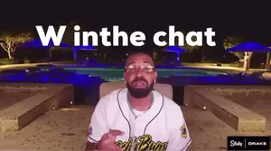 A Man Sitting In Front Of A Pool With The Words " W In The Chat " On The Bottom