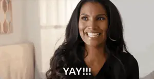 A Woman Is Smiling With The Word Yay Written On Her Face .