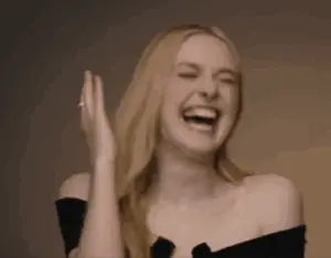 A Woman Is Laughing With Her Eyes Closed