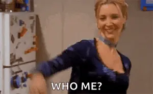 A Woman Is Standing In Front Of A Refrigerator And Smiling While Asking Who Me ?