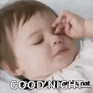 A Baby Is Sleeping With His Eyes Closed And Covering His Face With His Hand .