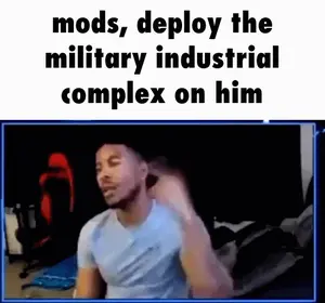 A Man Is Sitting In Front Of A Screen With The Words Mods Deploy The Military Industrial Complex On Him
