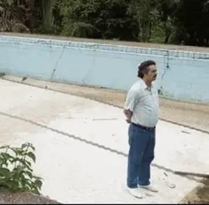 A Man Standing In Front Of A Swimming Pool