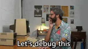 A Man Sitting At A Desk Talking On A Cell Phone With The Words Let 'S Debug This Written Below Him