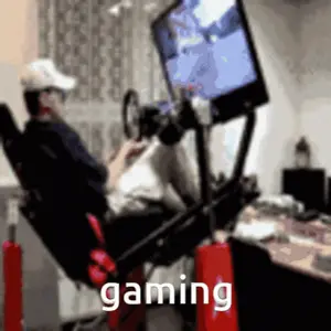 A Man Is Sitting In A Chair Playing A Video Game And The Word Gaming Is On The Bottom
