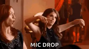 Two Women Are Standing Next To Each Other In A Room And One Of Them Is Pointing At The Camera .