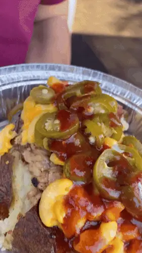 A Close Up Of A Plate Of Food With Sauce And Jalapenos On Top
