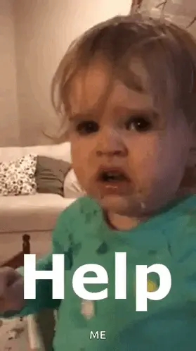 A Baby In A Green Shirt With The Word Help On It