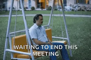 A Man Is Sitting On A Swing In A Park Waiting To End This Meeting .