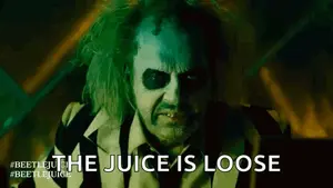 A Close Up Of A Man In A Striped Suit With The Words `` The Juice Is Loose '' Written On His Face .