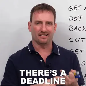 A Man Says There 'S A Deadline While Writing On A Whiteboard