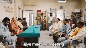 A Group Of People Are Sitting Around A Table With The Words Kijiye Meeting Meeting On The Bottom
