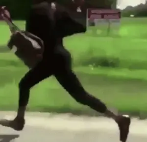 A Person Is Running Down A Sidewalk With A Backpack On Their Back .