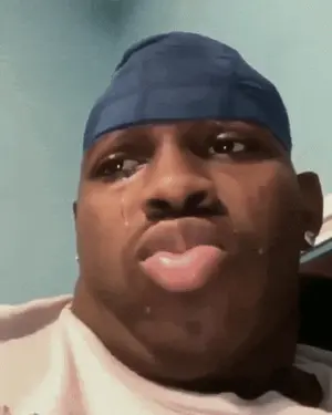 A Man Wearing A Blue Headband Has A Tear Running Down His Face