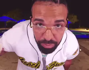 A Man With Glasses And A Beard Wearing A White Shirt That Says Beach Boys