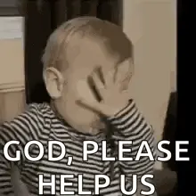 A Baby Is Covering His Face With His Hand .