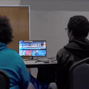 Two People Are Playing A Video Game Which Says " Body Fight " On The Screen