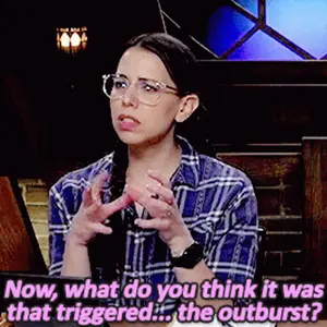 A Woman Wearing Glasses And A Plaid Shirt Says Now What Do You Think It Was That Triggered The Outburst ?