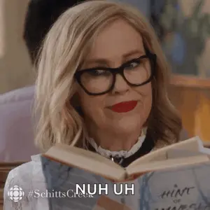 A Woman Wearing Glasses Is Reading A Book And Says " Nuh Uh " At The Bottom