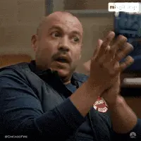 A Man With A Chicago Fire Logo On His Vest Is Clapping