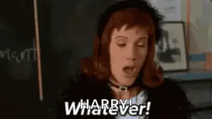 A Woman With Red Hair Is Standing In Front Of A Blackboard And Says `` Whatever '' .