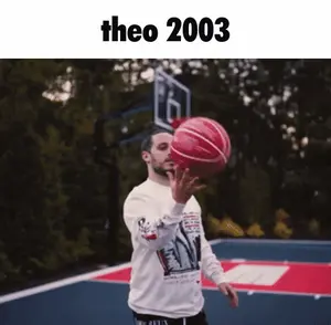 A Man Is Holding A Basketball On A Court With The Year 2003 On The Bottom