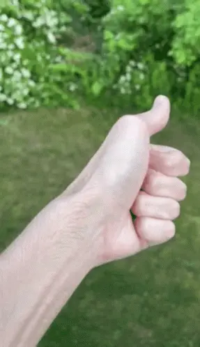 A Close Up Of A Person 'S Hand Giving A Thumbs Up Sign