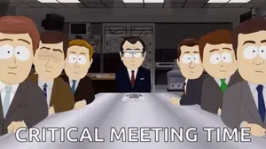 A Group Of Men Are Sitting Around A Table With The Words `` Critical Meeting Time '' Written Above Them .