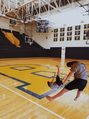 A Basketball Court With A Scoreboard That Says Louisa Alexander Palestine On It
