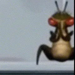 A Blurred Image Of A Bug With Red Eyes