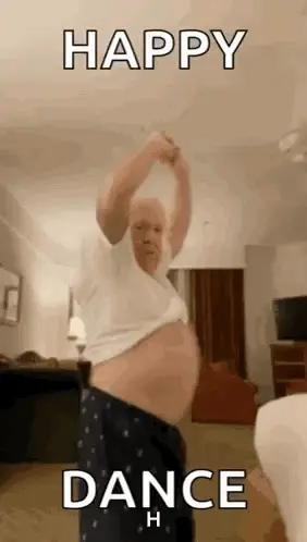 An Older Man Is Dancing In A Living Room While Wearing Pajamas And A White Shirt .