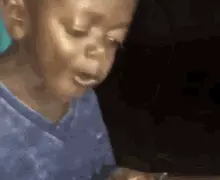 A Little Girl In A Blue Shirt Is Crying While Looking At A Tablet .