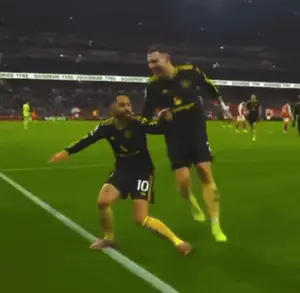 Two Soccer Players On A Field With One Wearing A Number 10 Jersey