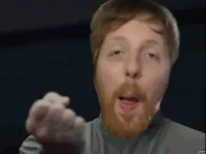 A Man With A Beard Is Pointing His Finger