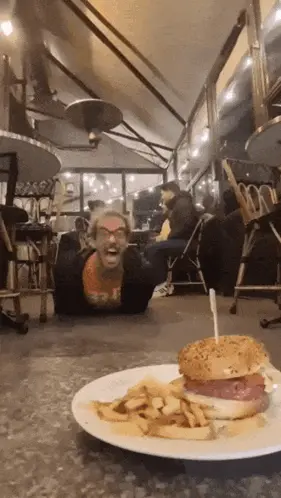 A Hamburger And French Fries On A Plate In A Restaurant