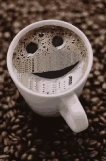 A Cup Of Coffee With A Smiley Face On The Top