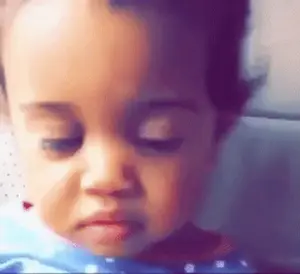 A Close Up Of A Baby 'S Face With A Sad Look On His Face .