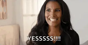 A Woman Is Smiling With The Words Yesssss Written On Her Face .