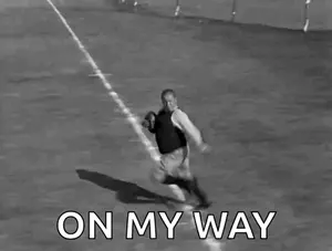 A Black And White Photo Of A Man Running With A Football With The Words On My Way Below Him