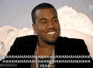 A Man With A Beard Is Sitting In A Chair And Smiling .