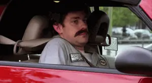 A Man With A Mustache Wearing A Shirt That Says Dunkin Donuts