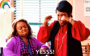 Two Women Are Standing Next To Each Other In A Classroom And One Of Them Is Shouting Yesss .