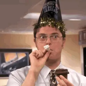 A Man Wearing A New Year 'S Eve Hat Is Eating A Cake