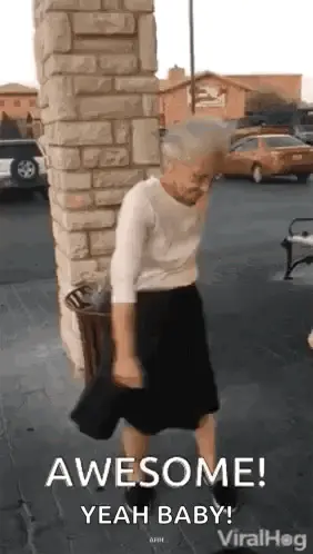 An Elderly Woman Is Dancing In A Parking Lot In Front Of A Brick Building .