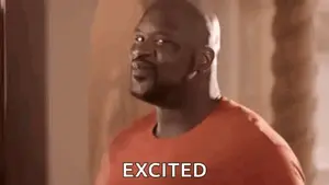 A Bald Man In An Orange Shirt Is Standing In Front Of A Punching Bag And Saying Excited .