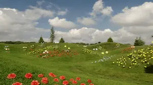 A Lush Green Field With Flowers And Trees In The Background