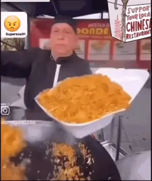 A Man Is Holding A Styrofoam Container Full Of Food In Front Of A Sign That Says Support Your Local Chinese Restaurant