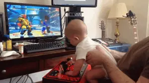 A Baby Is Playing A Video Game On A Dell Computer